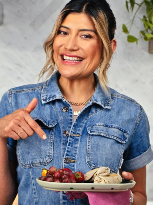 chef bricia lopez holding plate with burrito