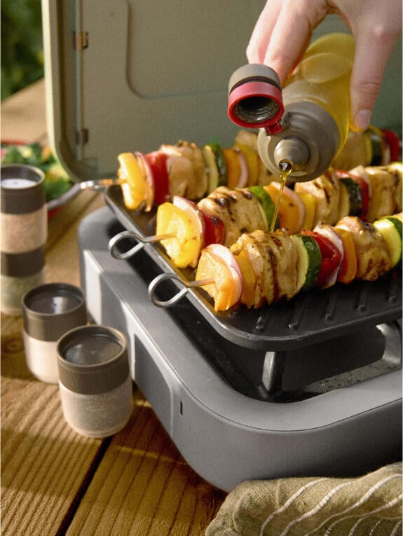 skewers on a camping grill